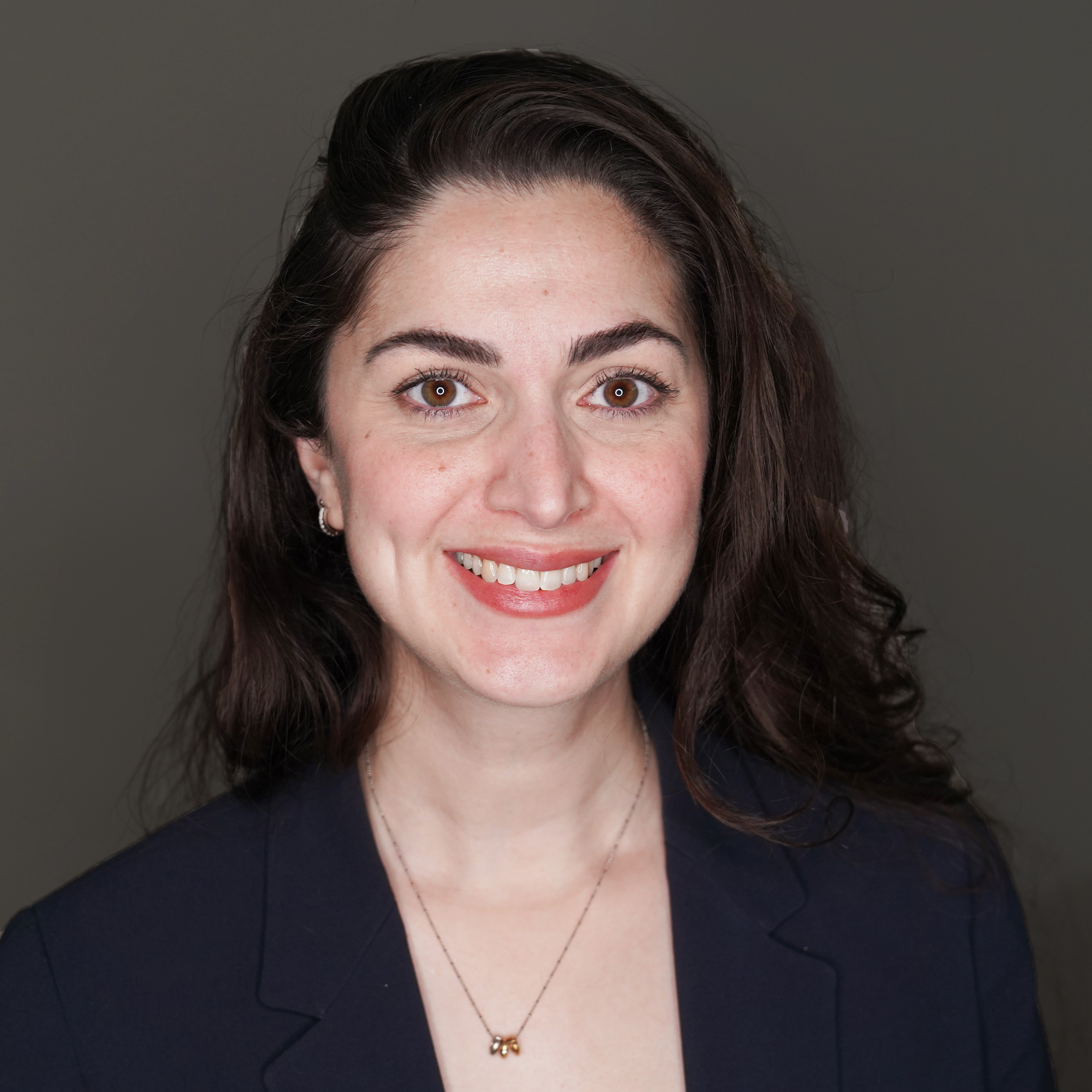Project Manager of Policy and Constituent Services Merci Mohagheghi headshot with dark background