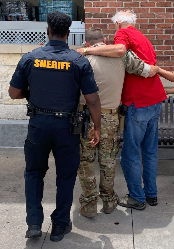 elderly escorted by sheriff